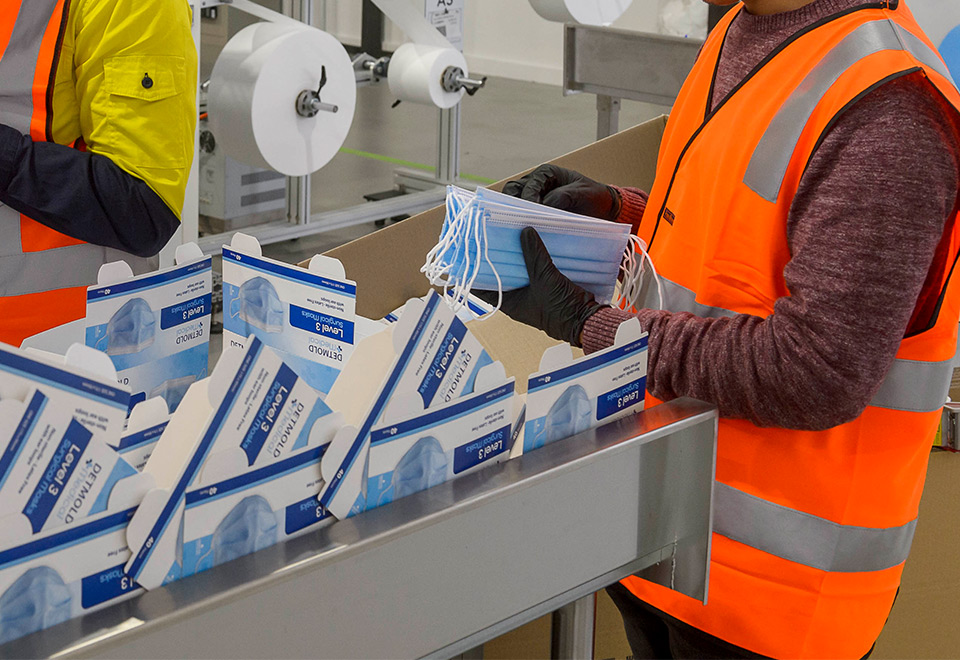 Image of masks being packed into cartons