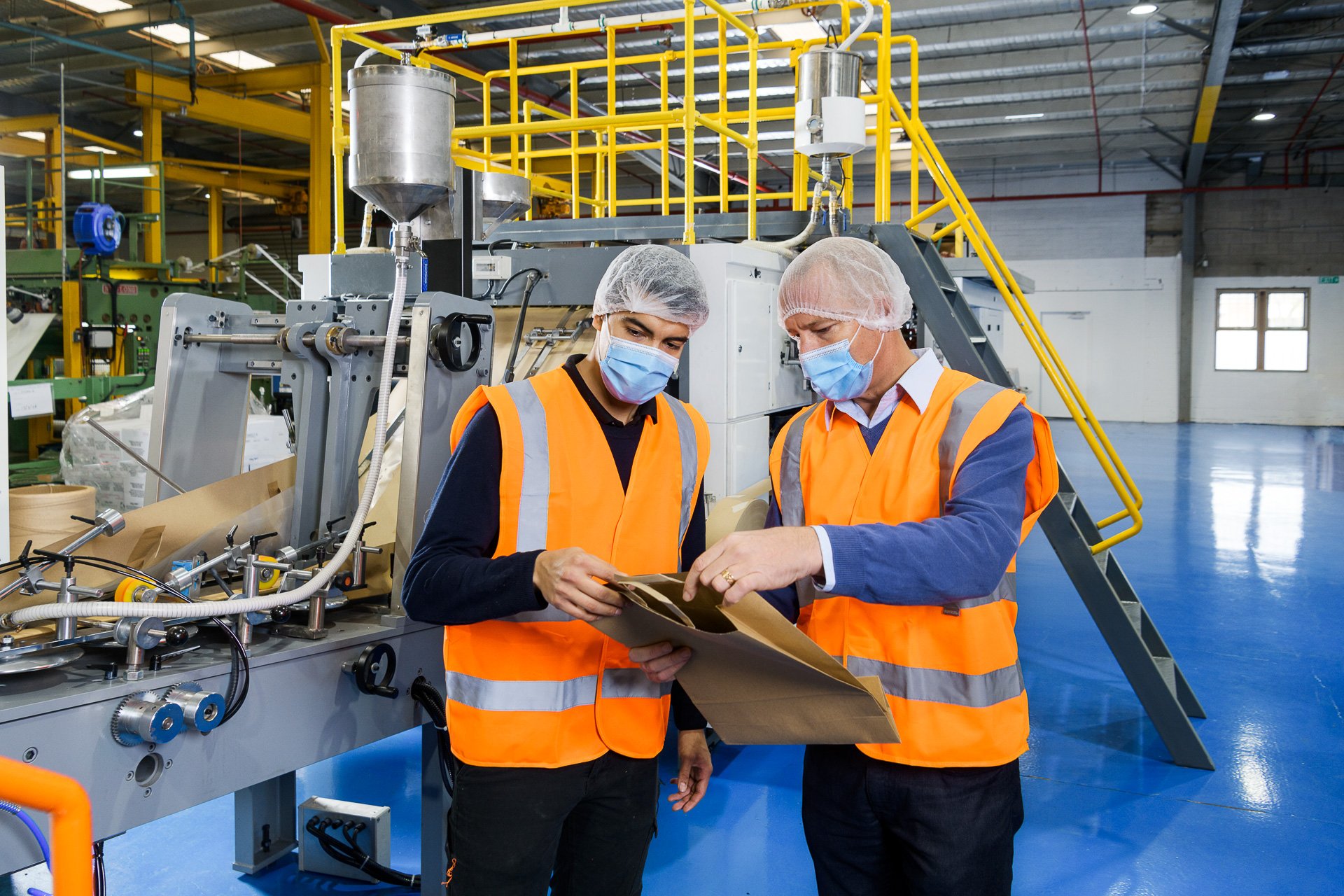 Conrad Groenewald stands in Adelaide manufacturing facility assessing product off a machine